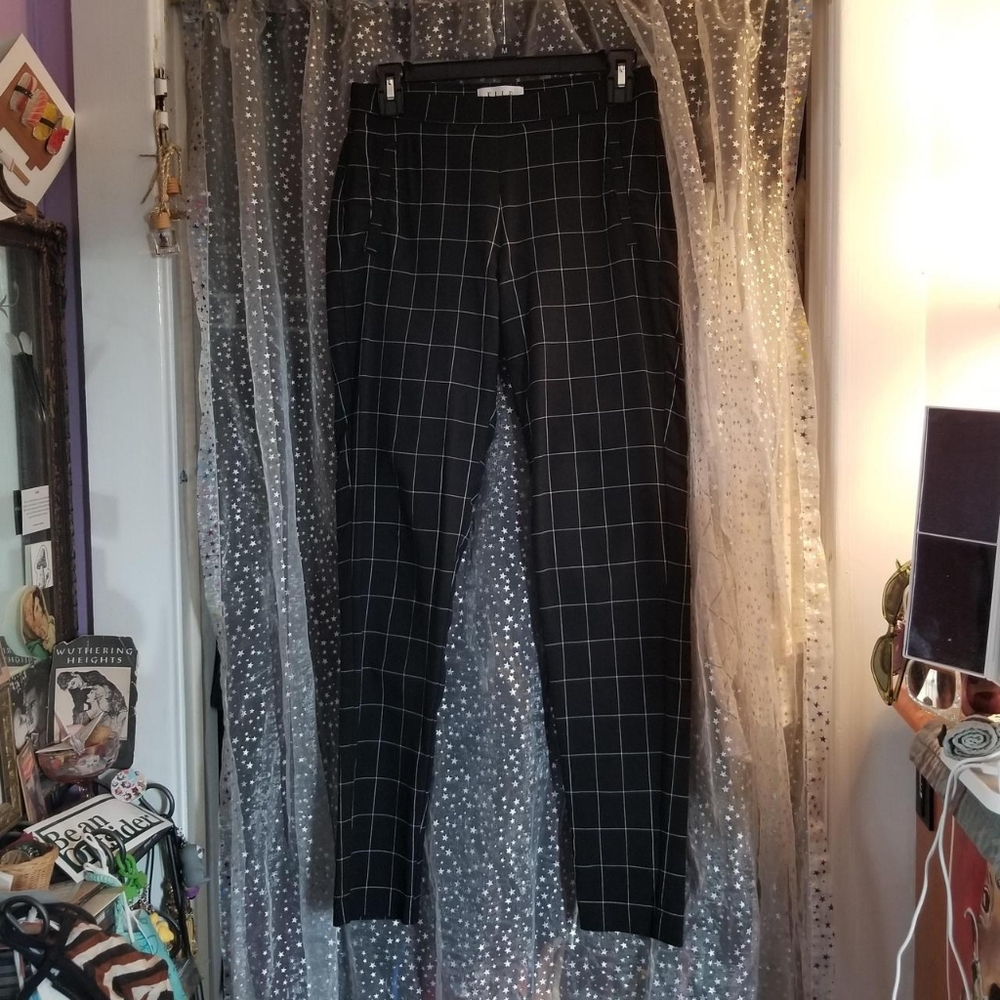 Skinny-styled, slightly stretchy black pants with white grid pattern. ELLE brand